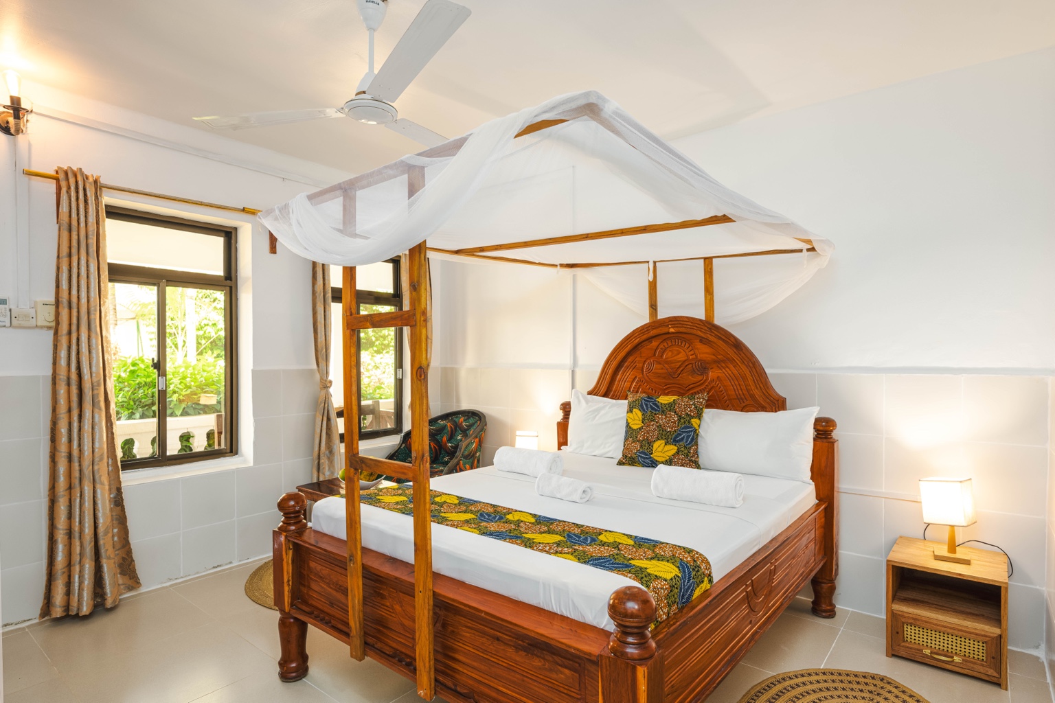 Standard Double Room — Double bed with canopy and bedside lamps